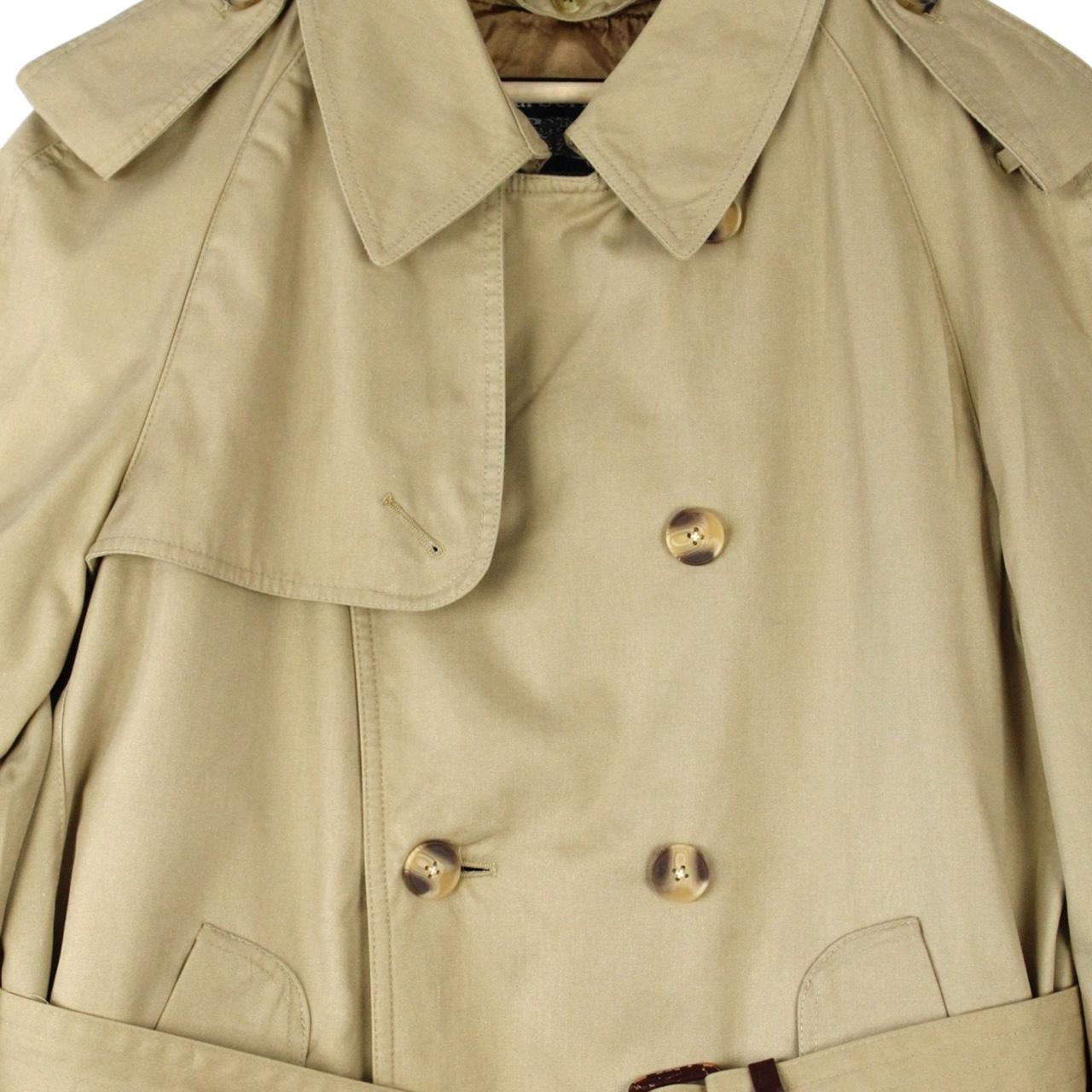 Burberry beige trench coat with Nova Check pattern, double breasted and belted design.