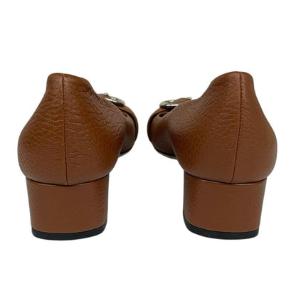 Gucci brown high heels with pebbled leather and interlocking G buckle detail.
