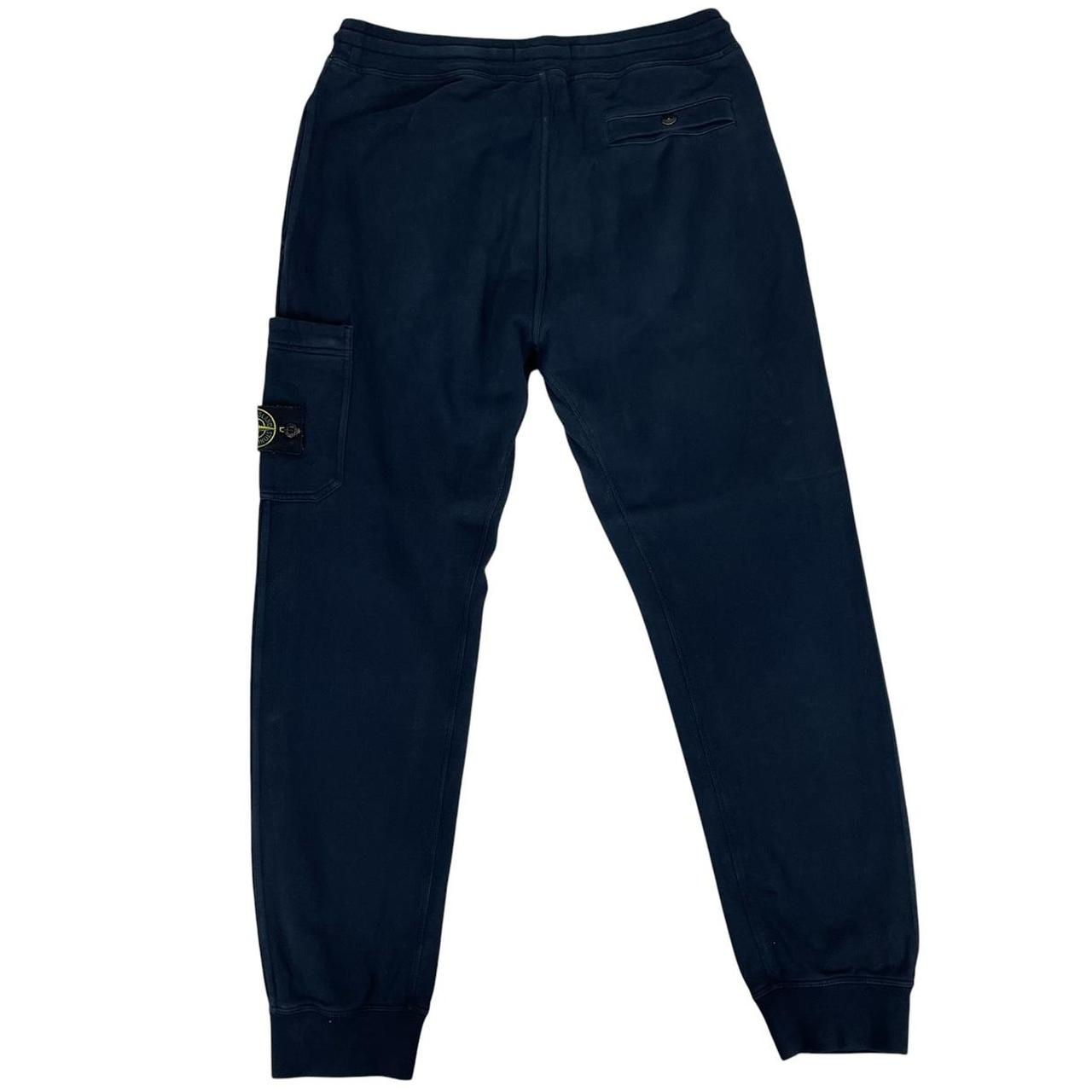 Stone Island navy blue joggers with logo patch and cotton material.