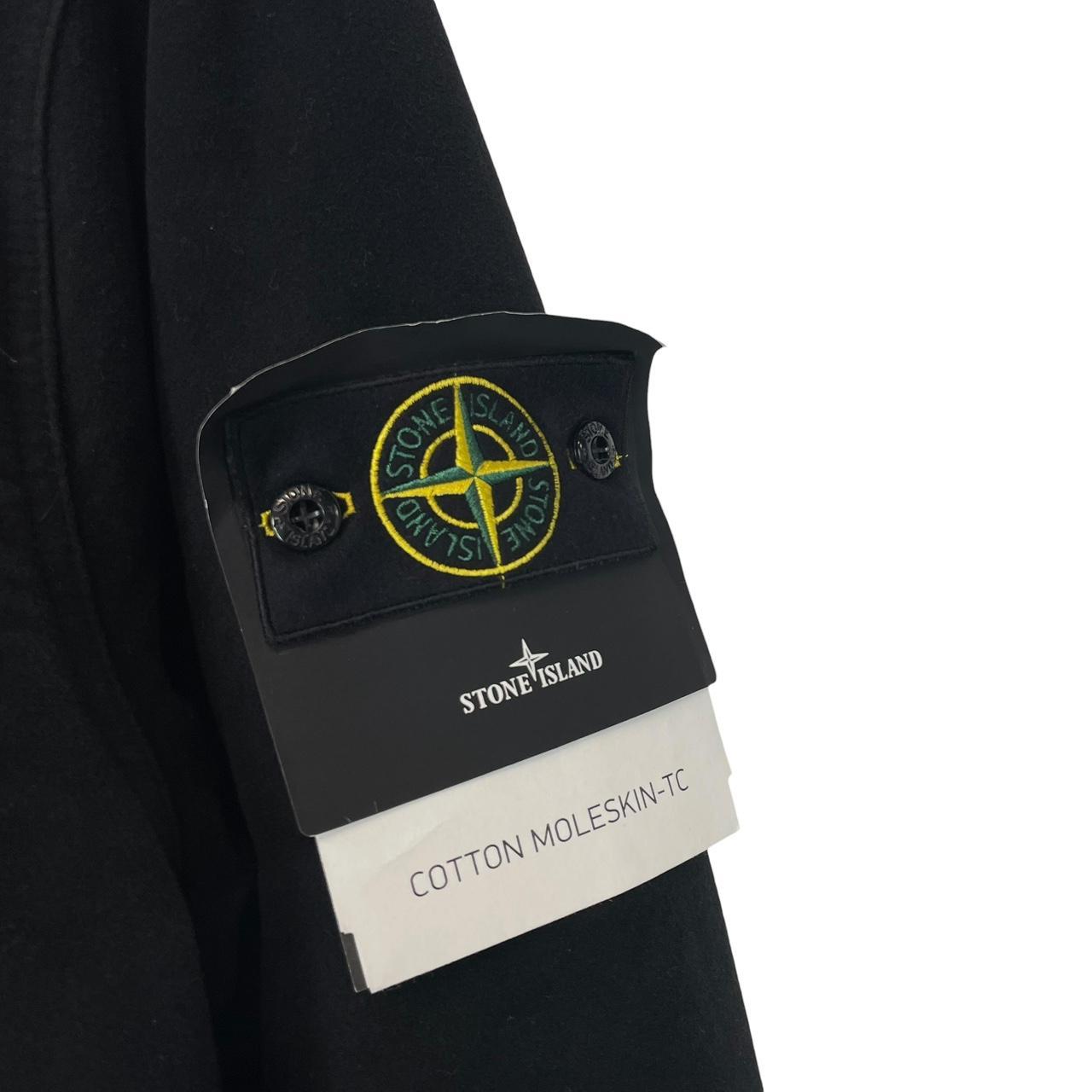 Stone Island navy blue work jacket with detachable compass badge and button-down closure.