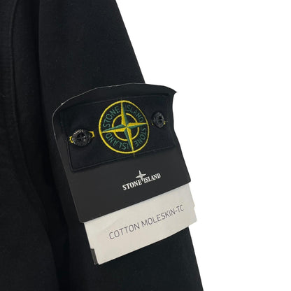 Stone Island navy blue work jacket with detachable compass badge and button-down closure.