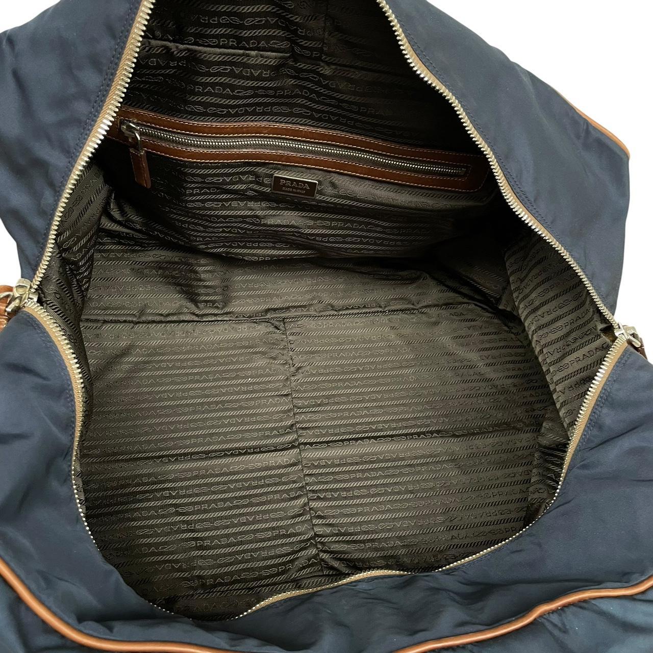 Prada navy blue and brown nylon duffel bag with signature logo and minimal wear.