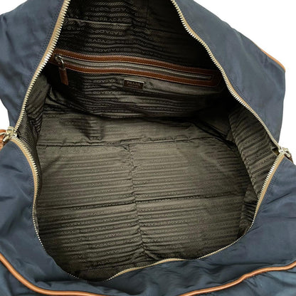 Prada navy blue and brown nylon duffel bag with signature logo and minimal wear.