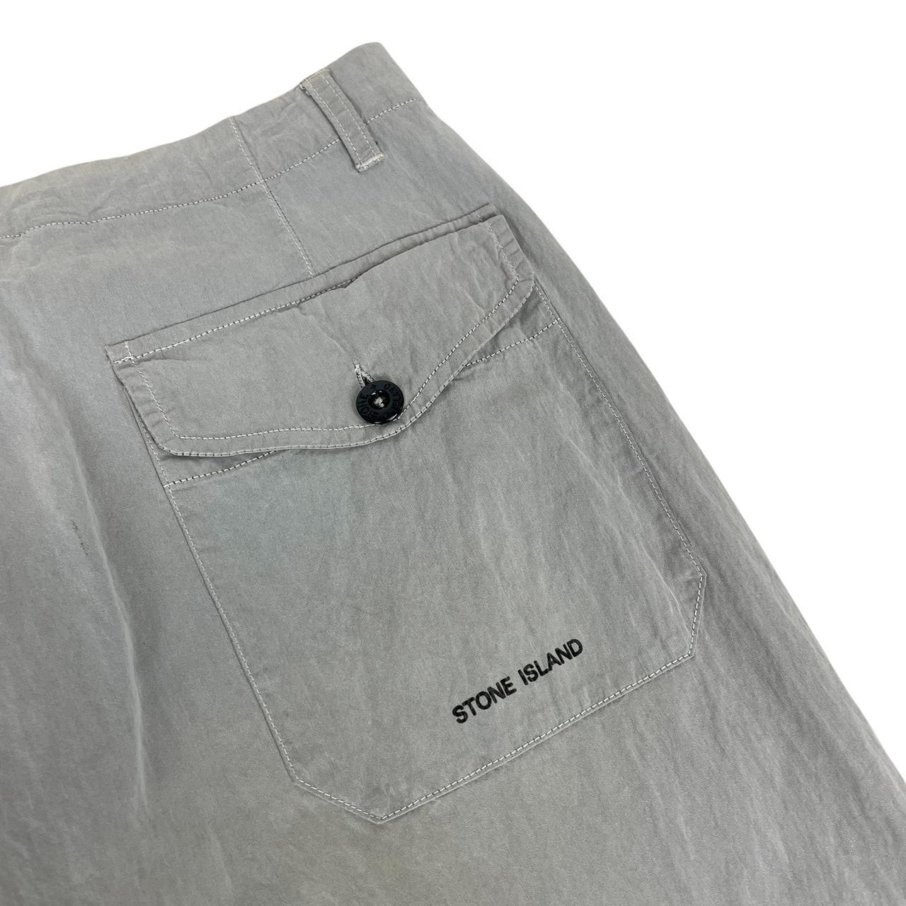 Stone Island grey tapered fit trousers with logo patch and cotton material.