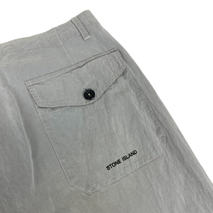 Stone Island grey tapered fit trousers with logo patch and cotton material.