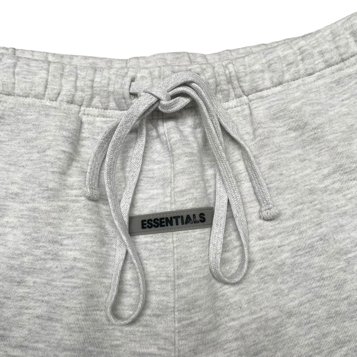 Essentials grey jogger shorts cotton material with logo detail and relaxed fit.