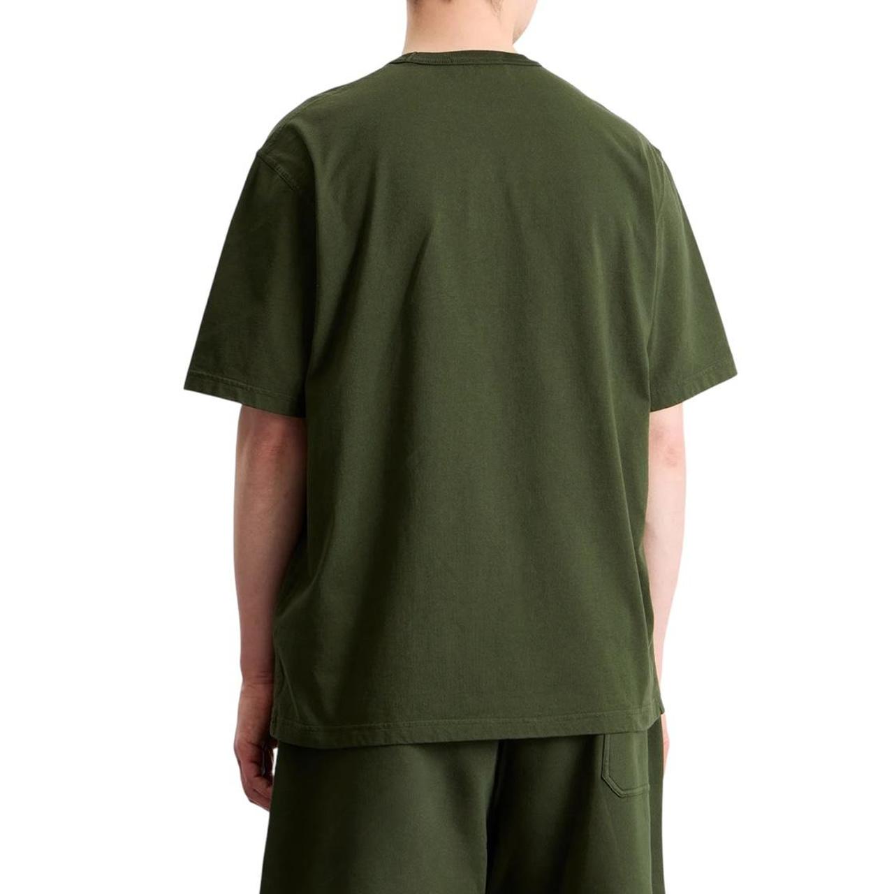 Stone Island green pocket t-shirt with embroidered crest and New Balance logo.