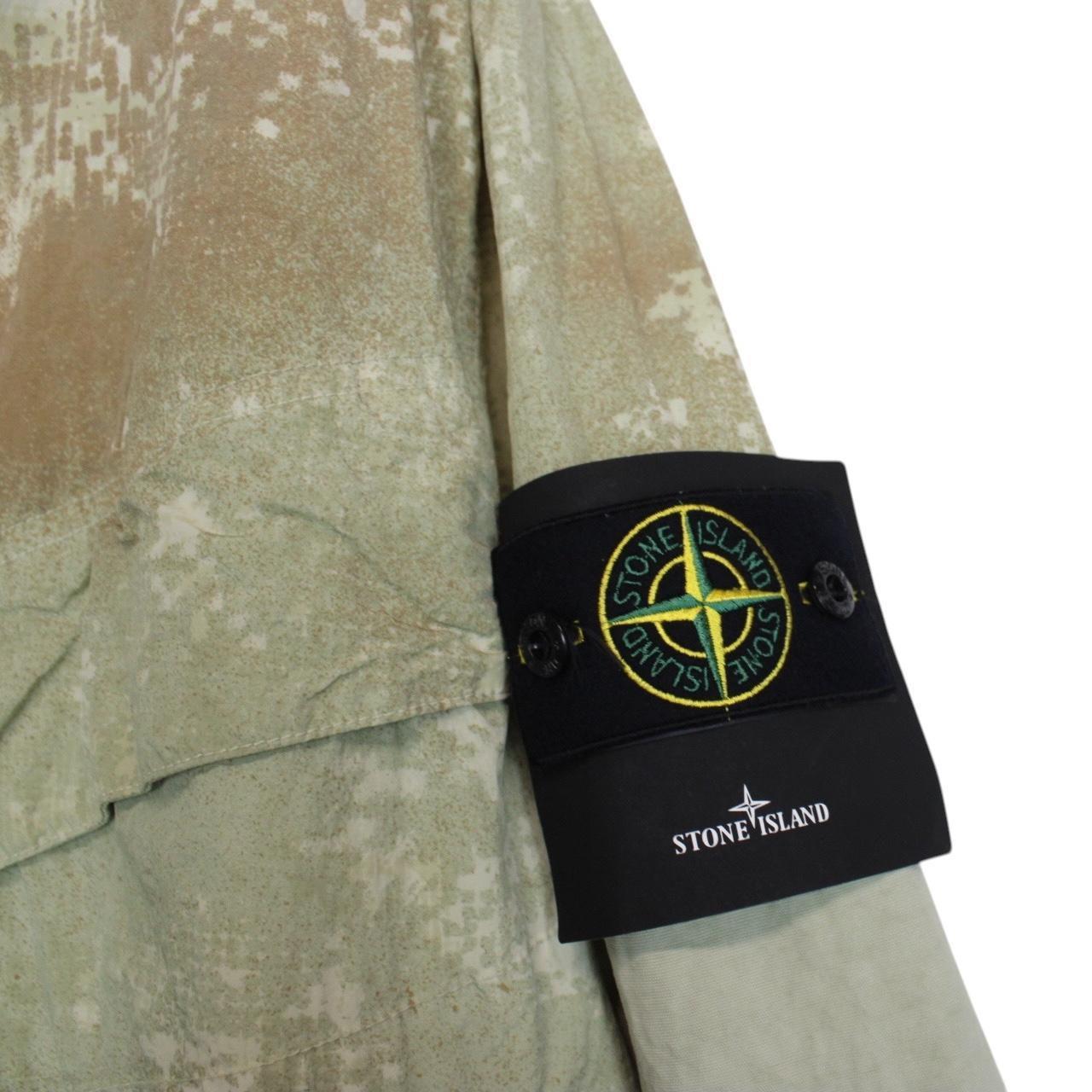 Stone Island green full zip jacket with dissolving grid camo pattern and logo patch.