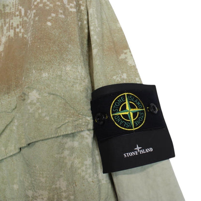 Stone Island green full zip jacket with dissolving grid camo pattern and logo patch.