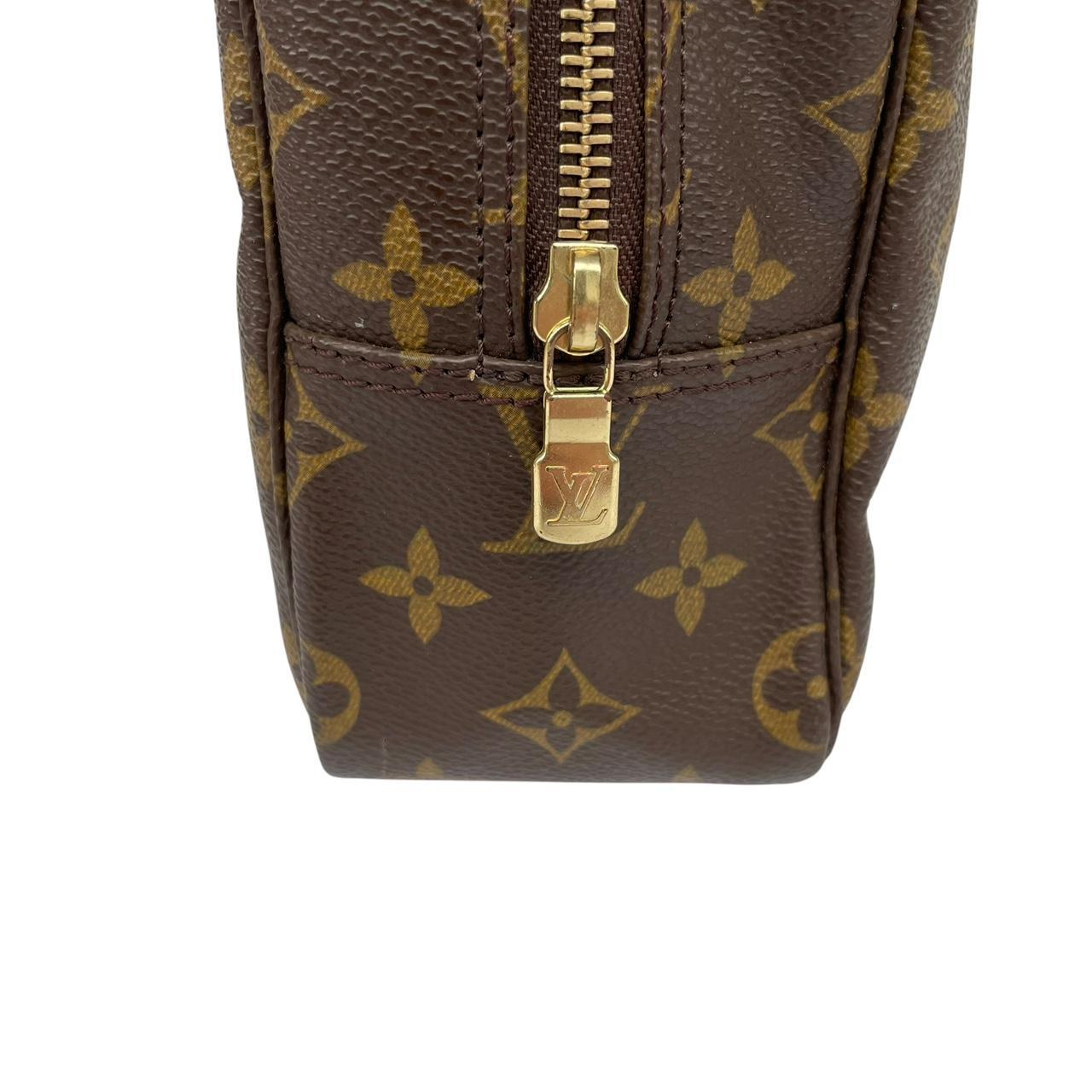 Louis Vuitton brown and tan monogram toiletry pouch with iconic logo and canvas material.