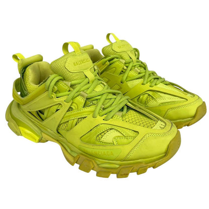 Balenciaga green low top trainers with logo detailing and textured mesh upper.