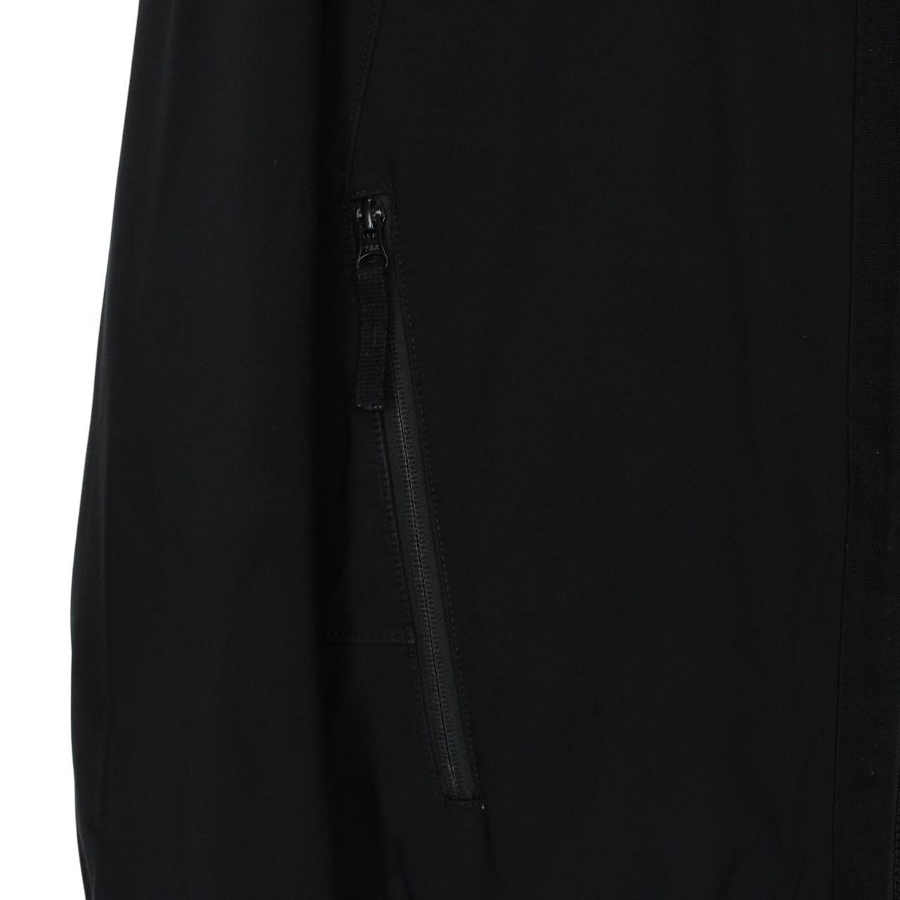 Stone Island black soft shell jacket with full zip and iconic compass logo.