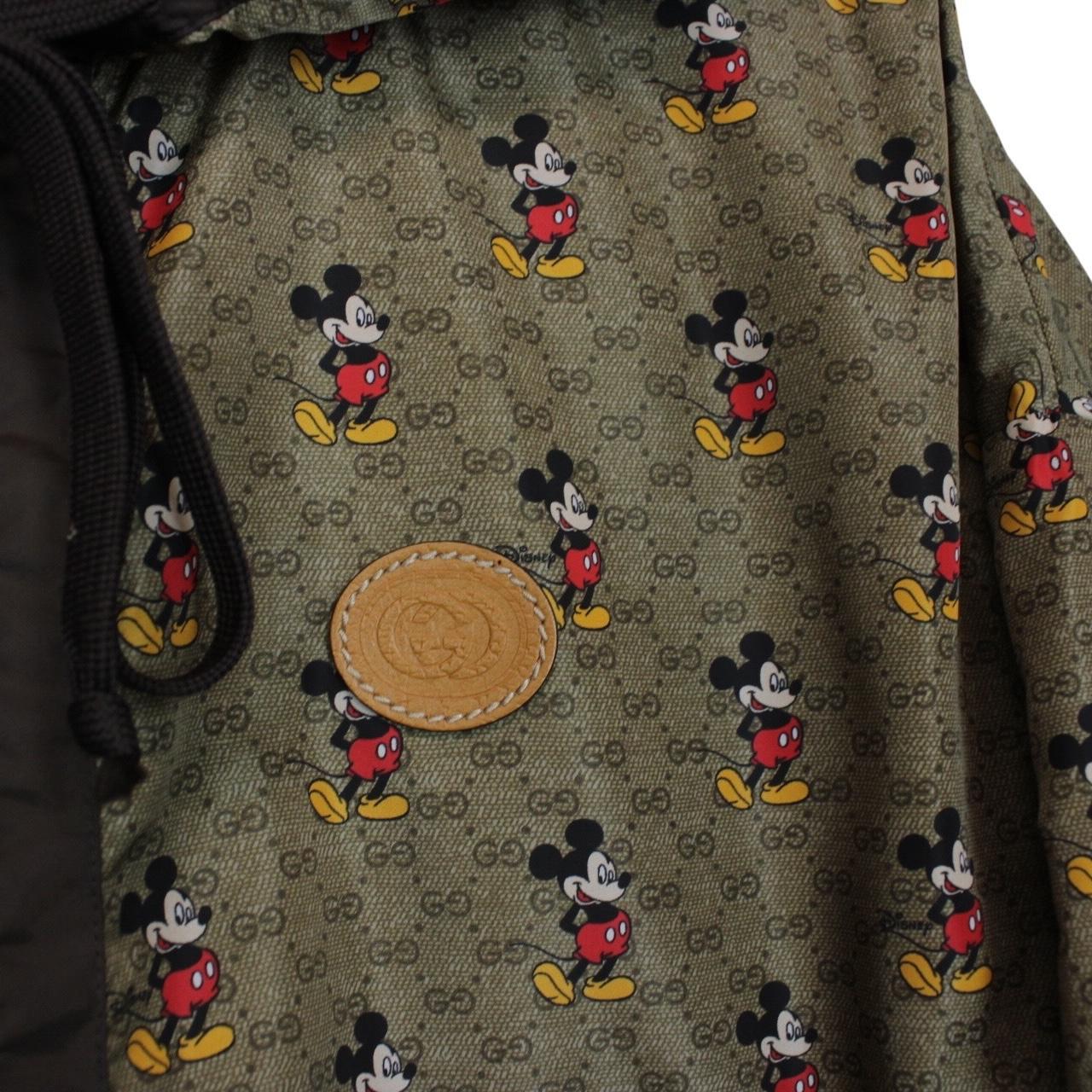 Gucci x Disney khaki brown windbreaker jacket with monogram pattern and nylon material.