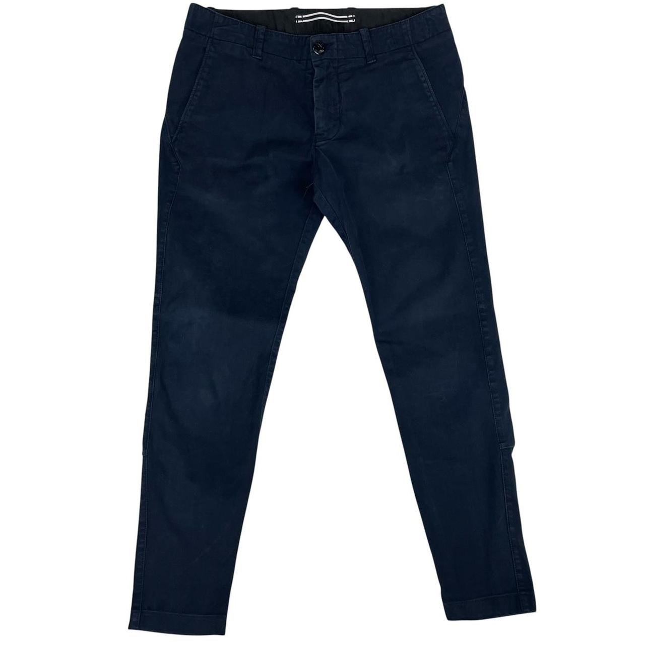 Stone Island navy blue skinny fit cotton trousers with logo patch and subtle wear.