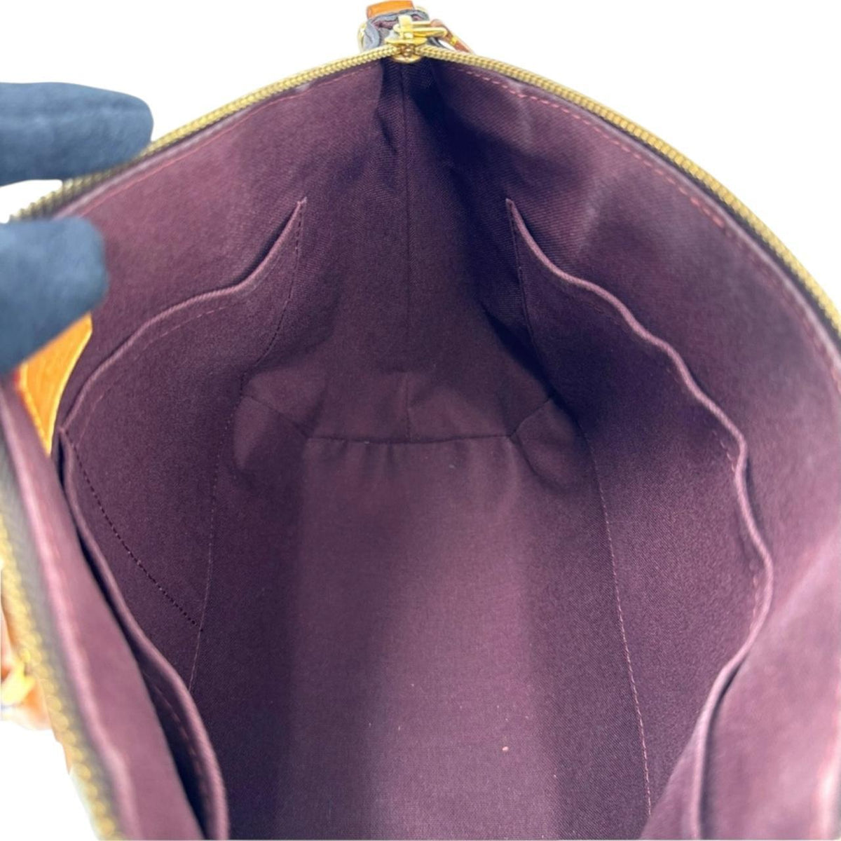 Louis Vuitton brown messenger bag with monogram canvas and leather trim details.