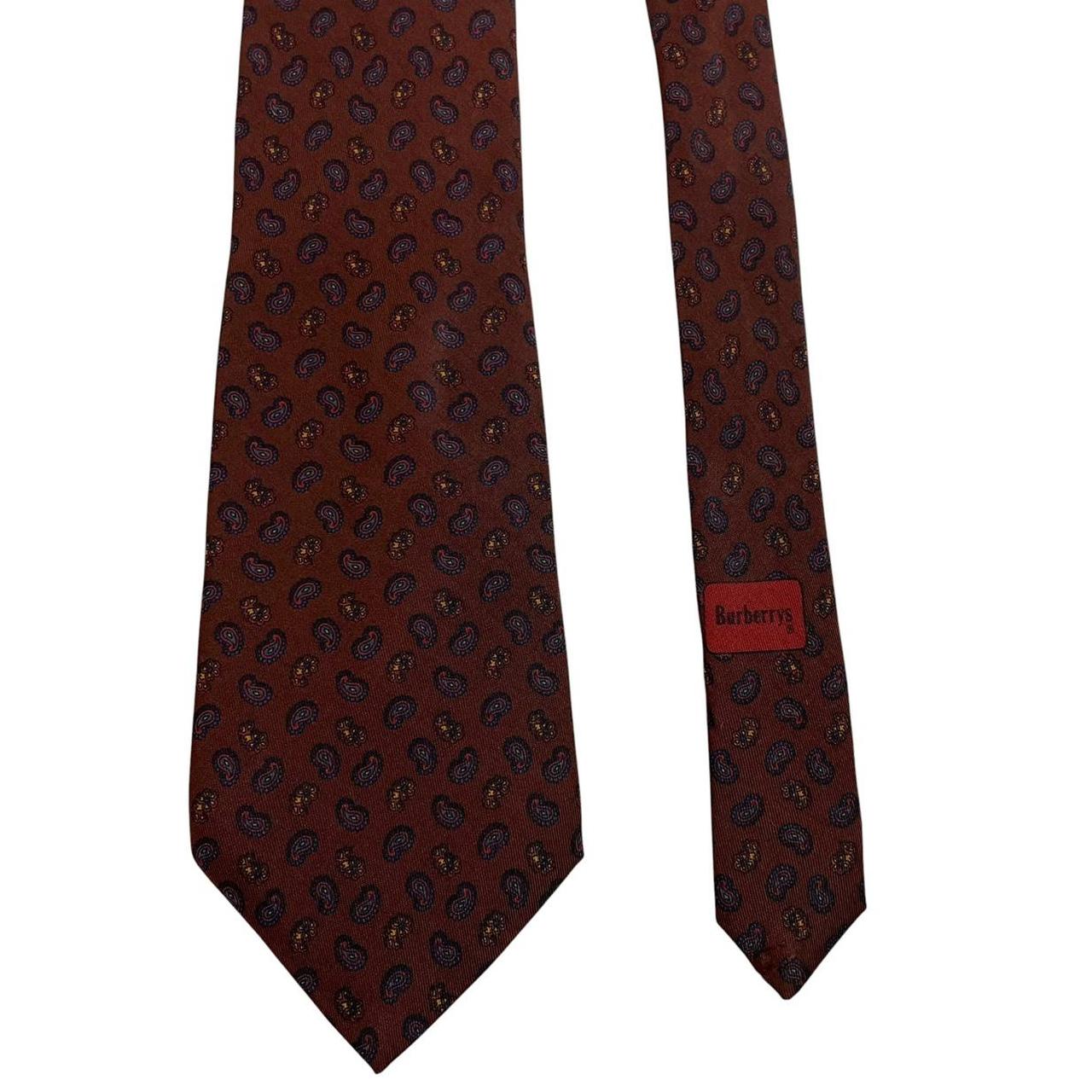 Burberry brown silk tie with vintage paisley print design and logo detail.