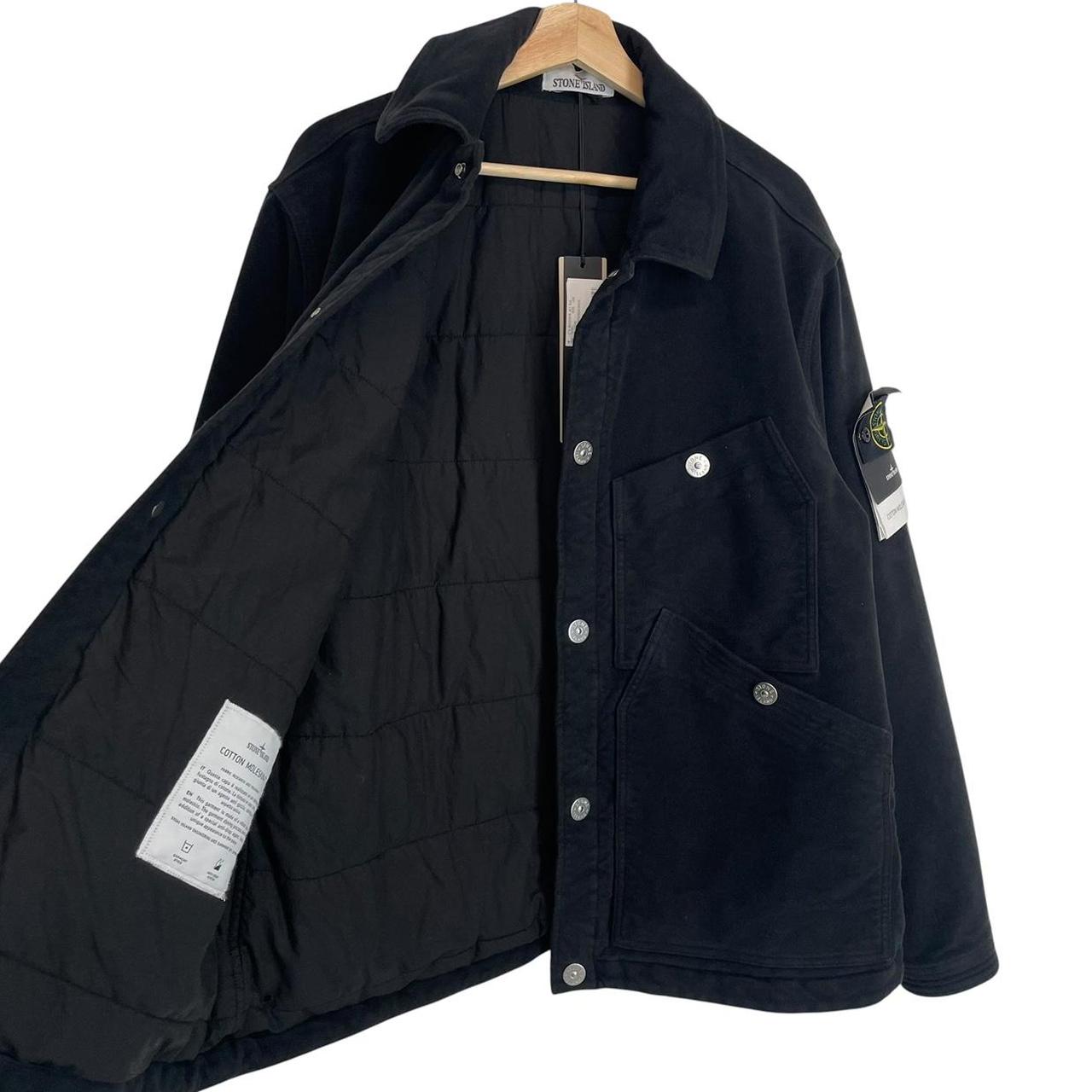 Stone Island navy blue work jacket with detachable compass badge and button-down closure.