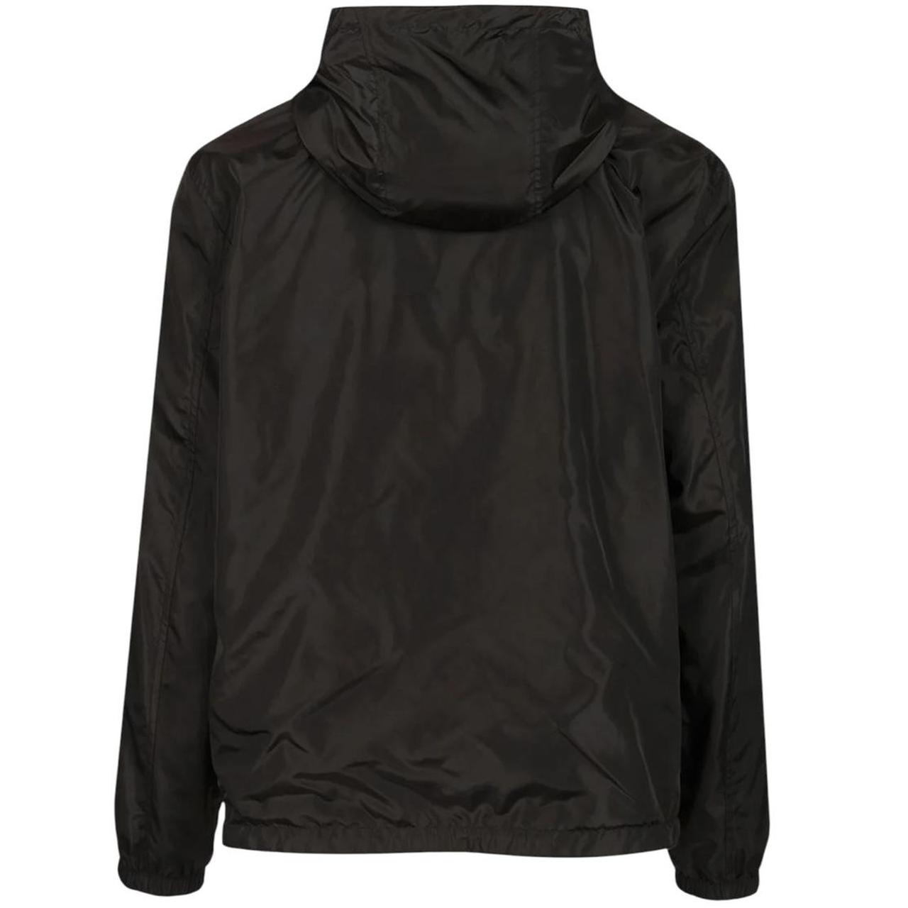 Burberry reversible windbreaker jacket in sand beige and black Nova Check pattern.