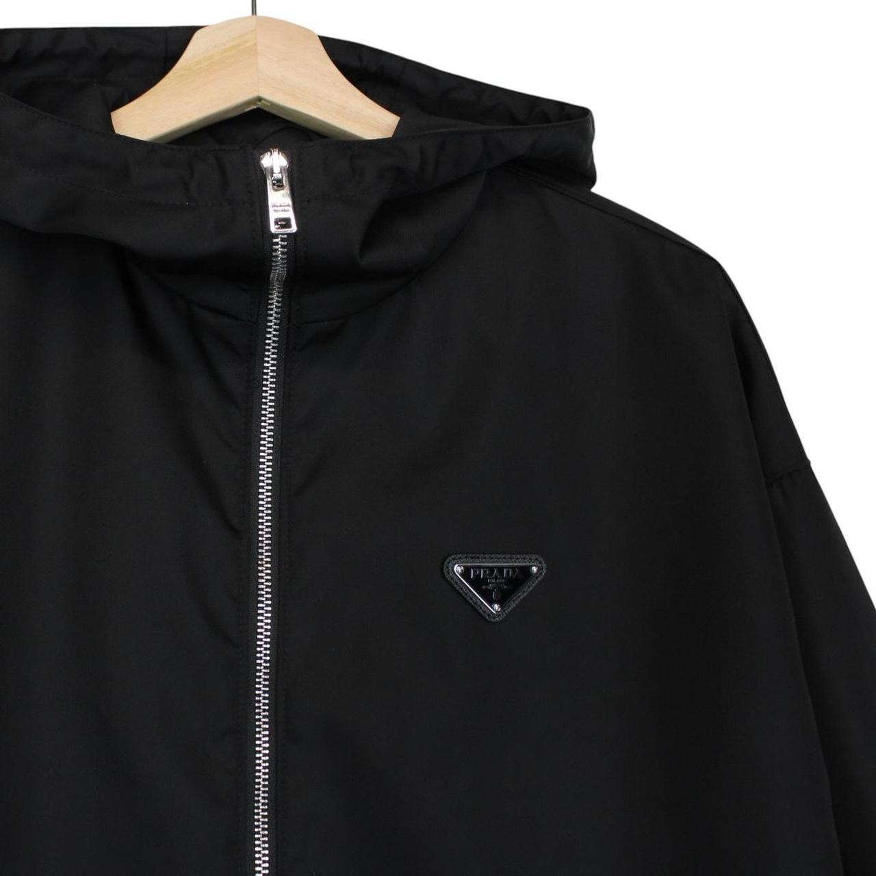 Prada black hooded jacket with full zip, Re-Nylon material, logo detail on sleeve.