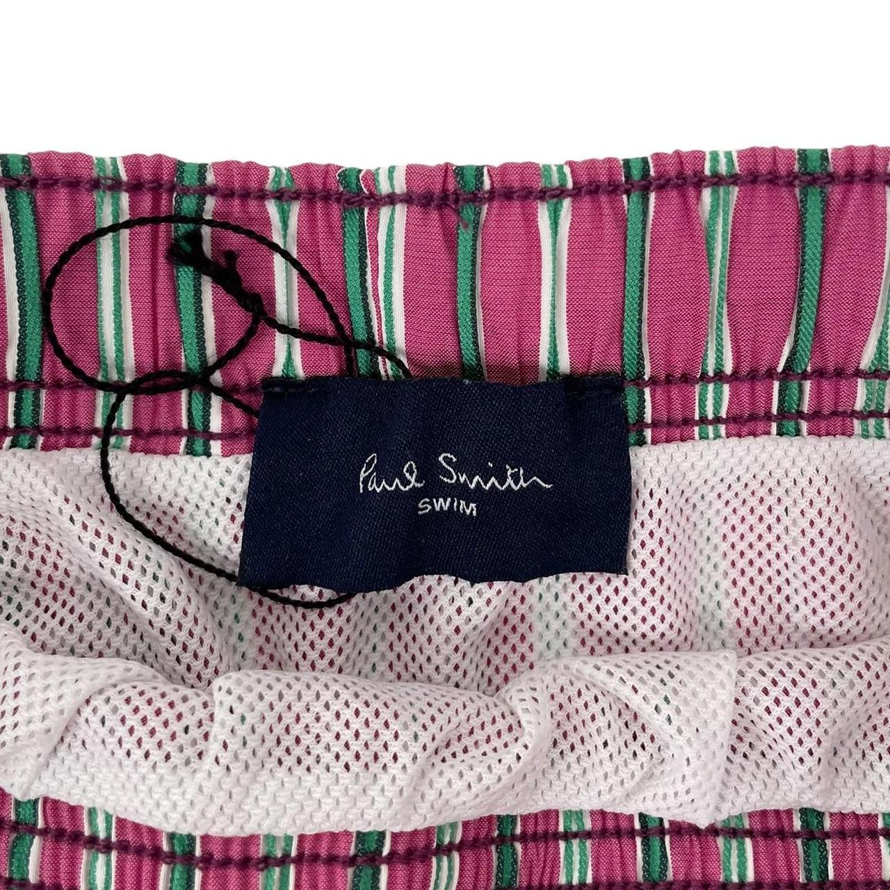 Paul Smith red swim shorts with striped pattern and cotton material.