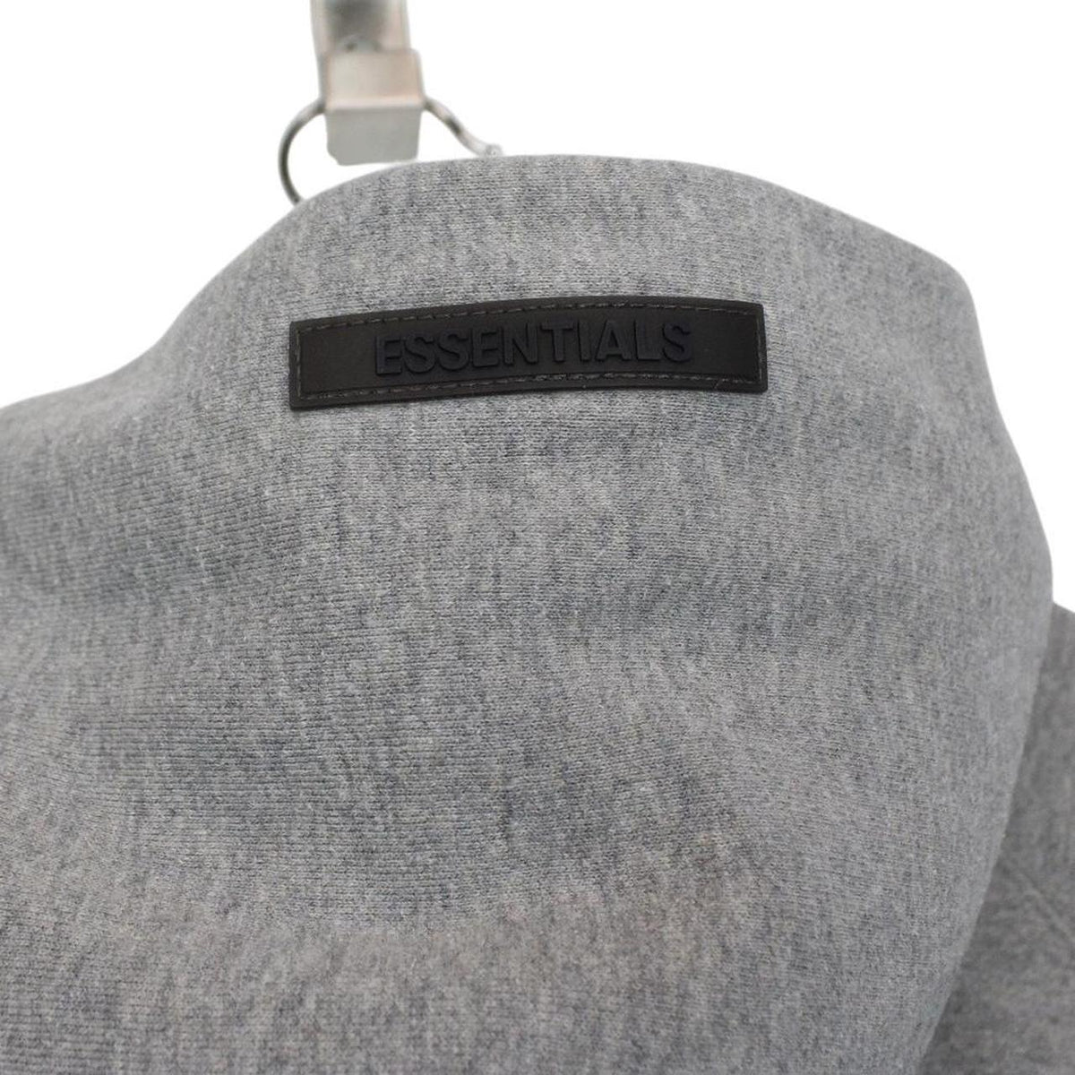 Essentials grey hoodie jumper with oversized fit and subtle logo detail.