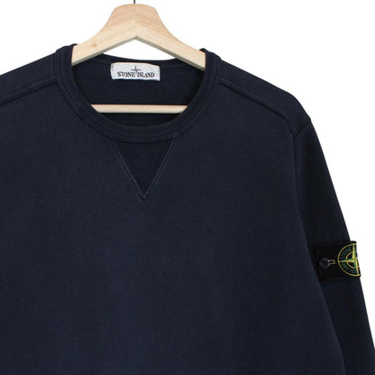 Stone Island navy blue cotton sweatshirt with iconic compass logo and ribbed cuffs.