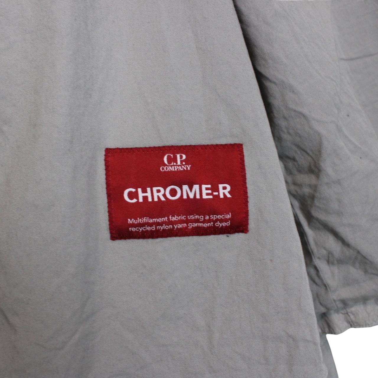 CP Company grey overshirt jacket with lens detail and garment dyed nylon fabric.