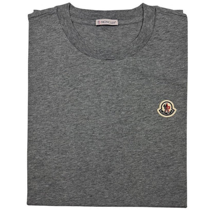 Moncler pocket t-shirts in black, grey, and white with patch logo details.