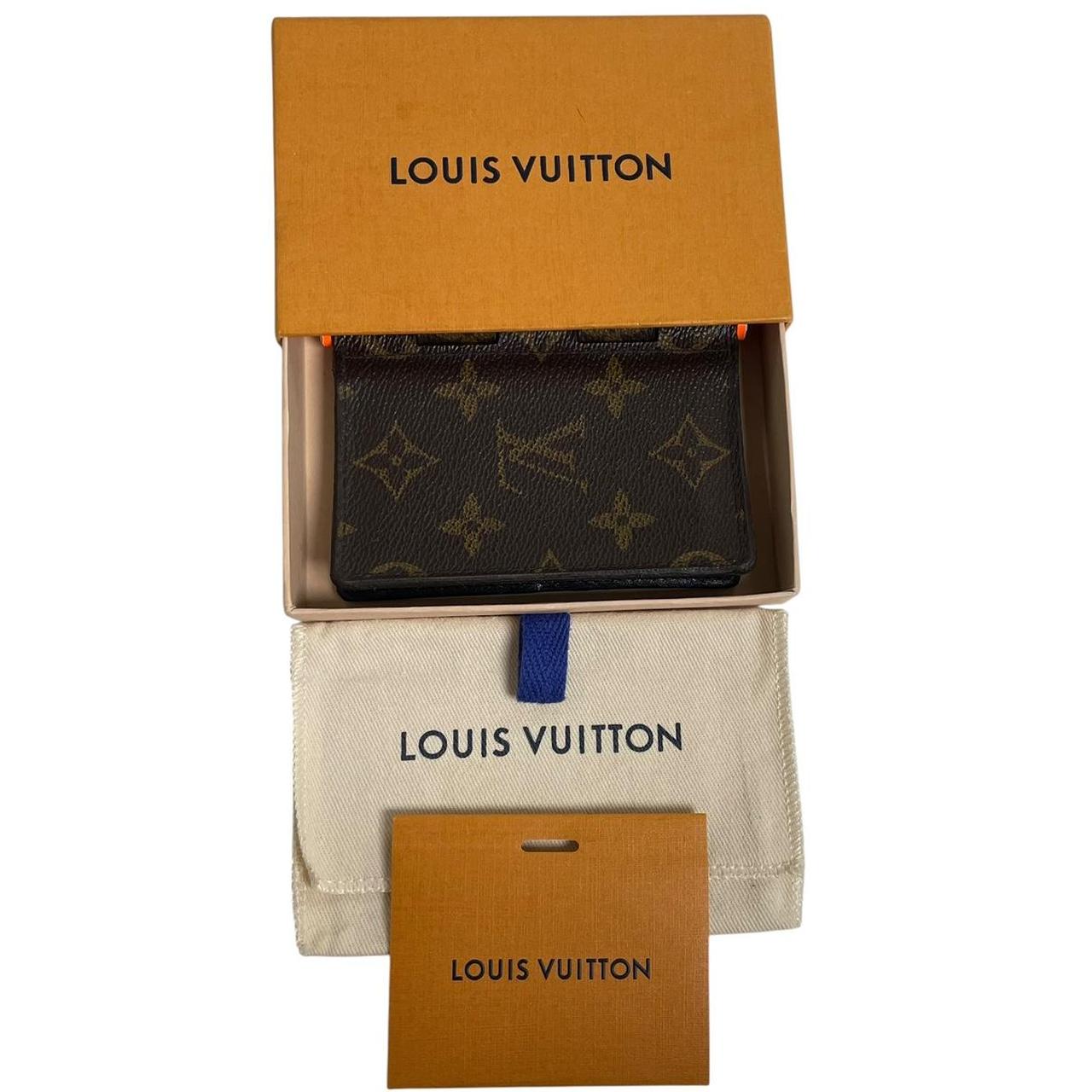 Louis Vuitton brown purse with orange metal hardware and iconic monogram pattern.