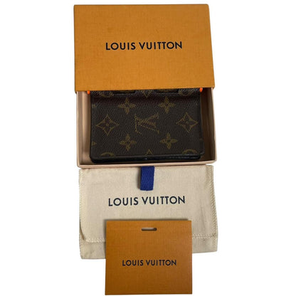 Louis Vuitton brown purse with orange metal hardware and iconic monogram pattern.