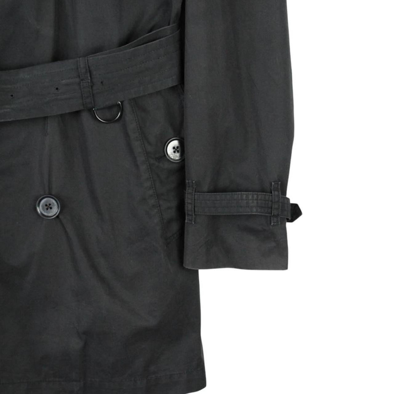 Burberry black trench coat featuring Nova Check pattern, double-breasted design, and belted waist.
