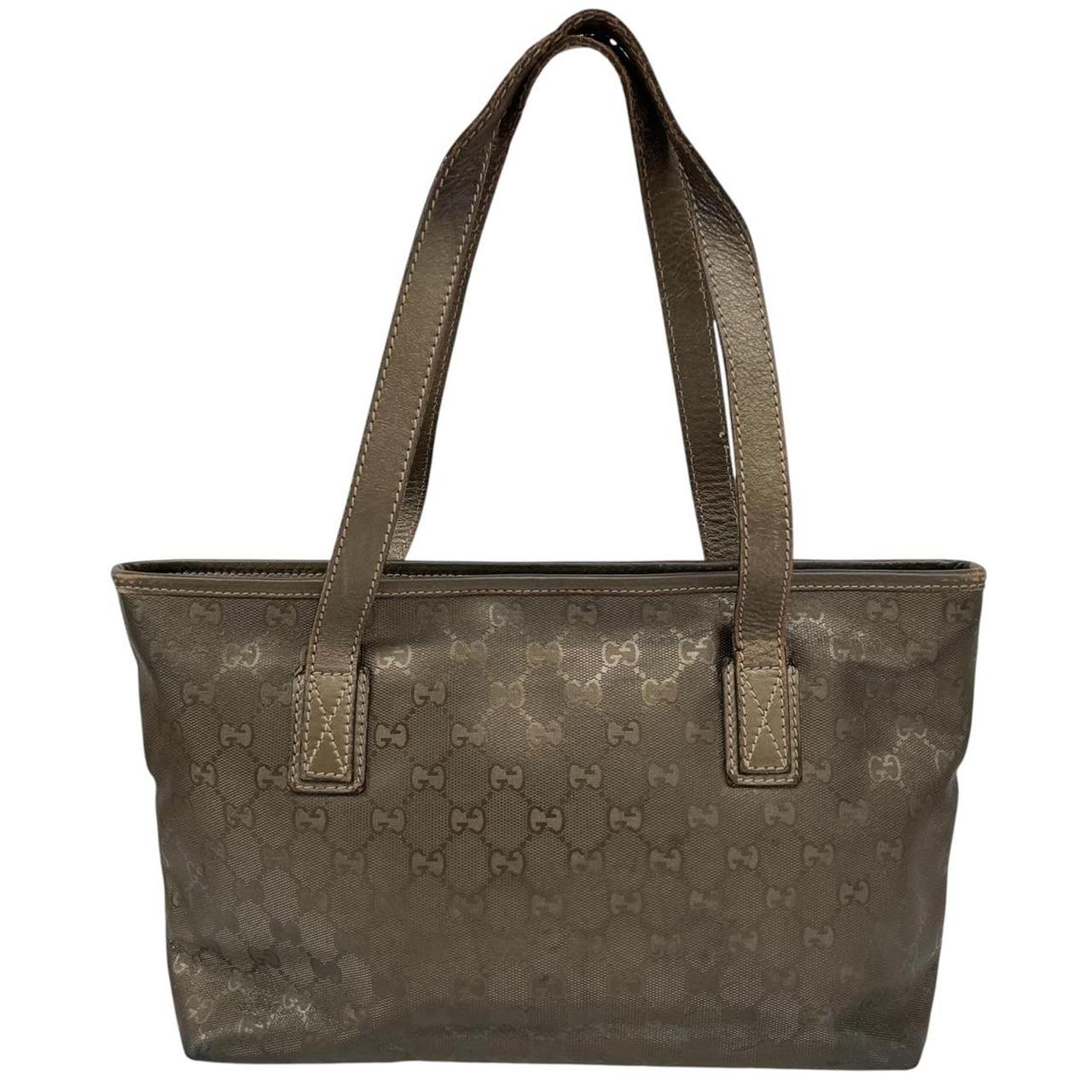 Gucci khaki green duffel bag with metallic monogram canvas and leather trim details.
