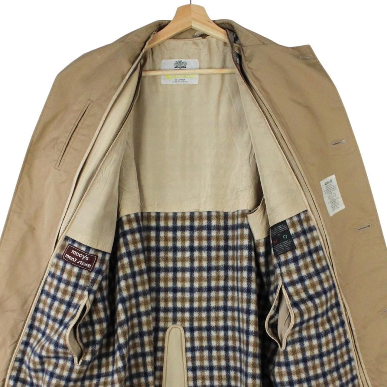 Aquascutum tan brown trench coat with house check pattern and removable wool lining.