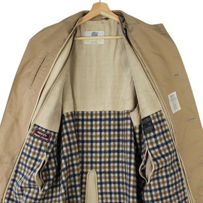Aquascutum tan brown trench coat with house check pattern and removable wool lining.