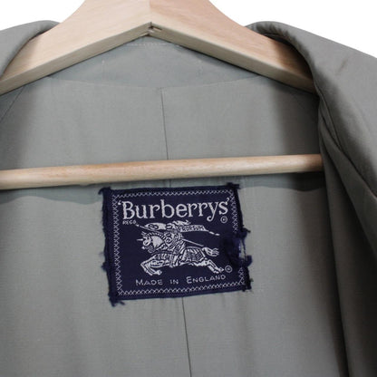 Burberry green trench coat with Nova Check pattern and single-breasted design.