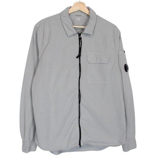 CP Company grey full zip overshirt jacket with lens detail and cotton material.