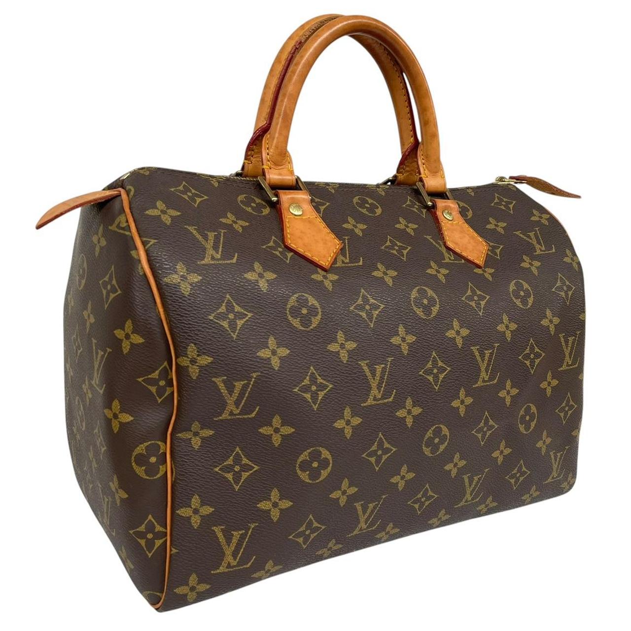 Louis Vuitton duffel bag beige and brown monogram coated canvas with leather trim.