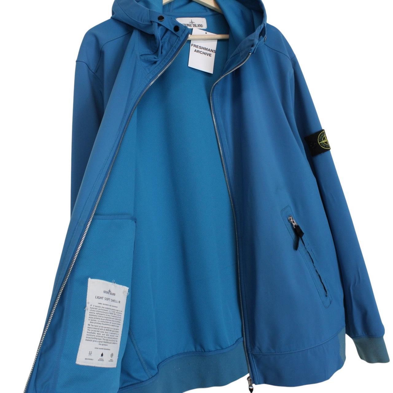 Stone Island blue full zip jacket with logo patch and soft shell material.