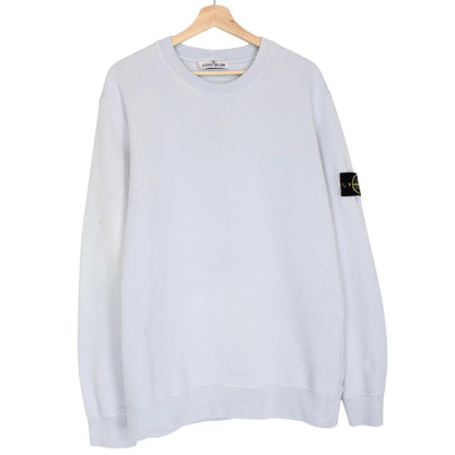 Stone Island blue cotton sweatshirt with logo patch and faded left sleeve.