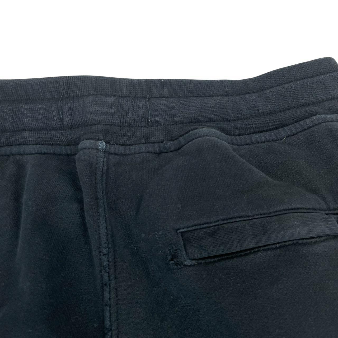 Stone Island navy blue joggers with logo patch and cotton material, pre-owned condition.