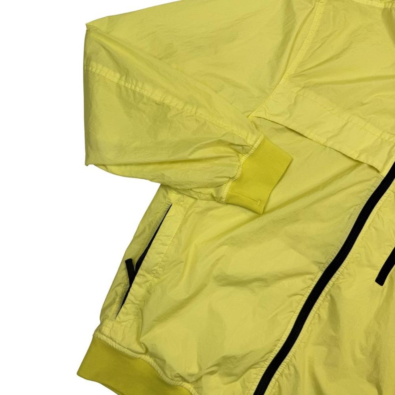 Stone Island yellow full zip jacket with crinkle texture and iconic compass logo.