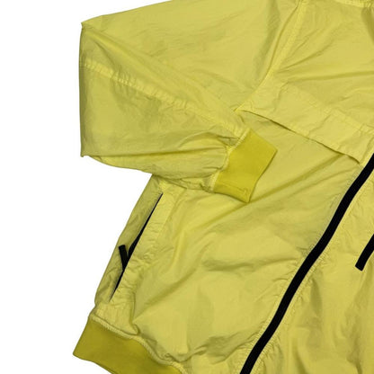 Stone Island yellow full zip jacket with crinkle texture and iconic compass logo.