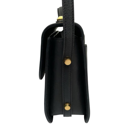 Alexander McQueen black and gold leather messenger bag with logo detailing and faint scratches.