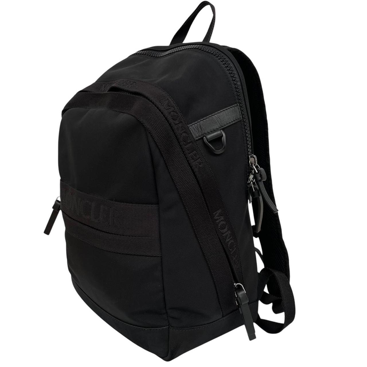 Moncler black duffel bag with logo patch and durable material, pre-loved condition.