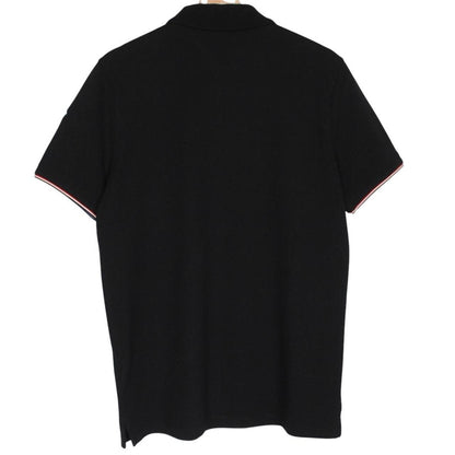 Moncler black short sleeve polo shirt with embroidered logo and cotton material.