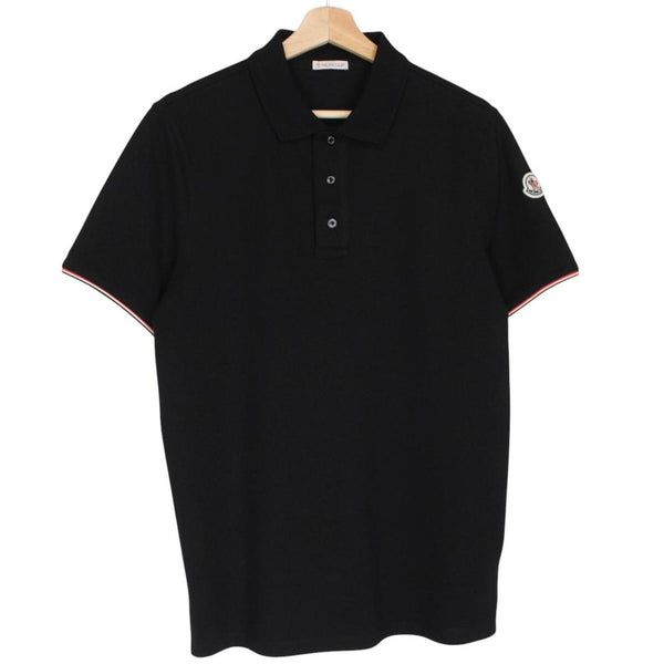 Moncler black short sleeve polo shirt with embroidered logo and cotton material.