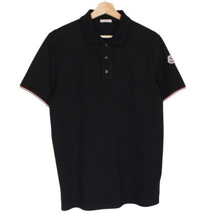 Moncler black short sleeve polo shirt with embroidered logo and cotton material.