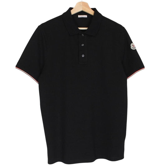 Moncler black short sleeve polo shirt with embroidered logo and cotton material.