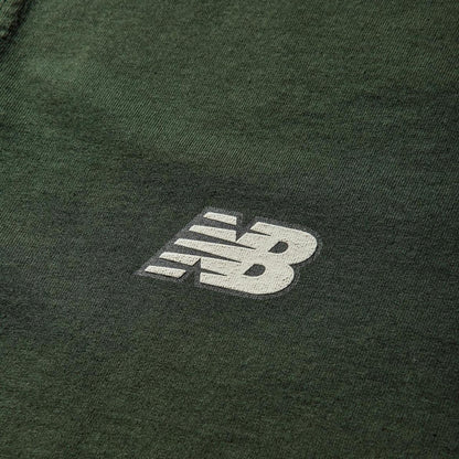 Stone Island green pocket t-shirt with embroidered crest and New Balance logo.