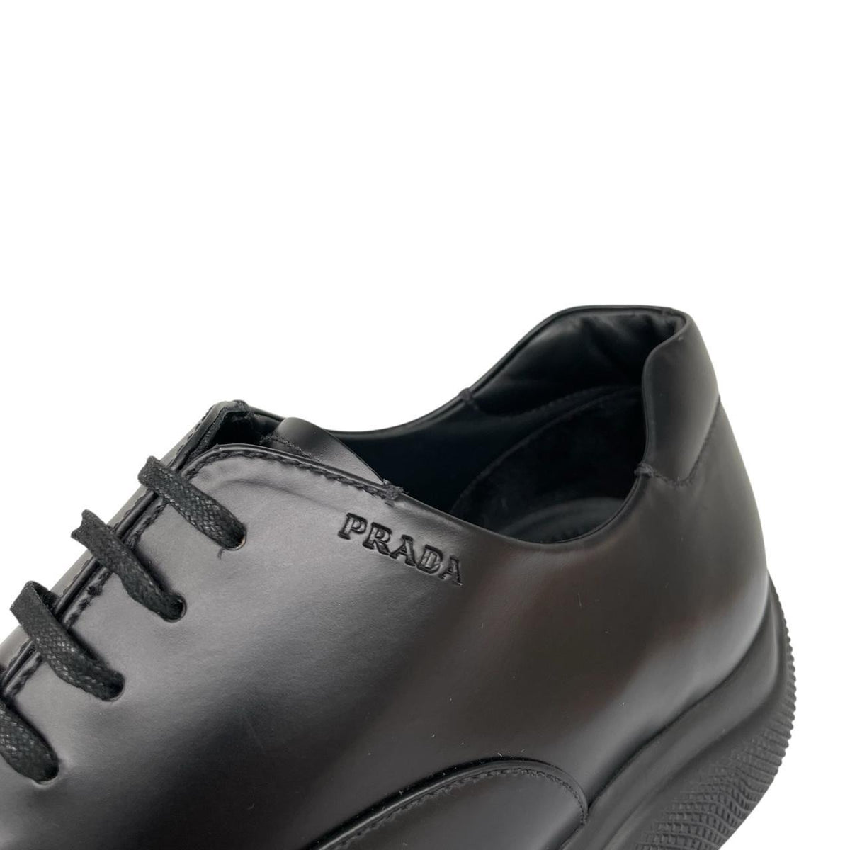 Prada black leather laced derby loafers with subtle signs of wear, includes original dust bags.